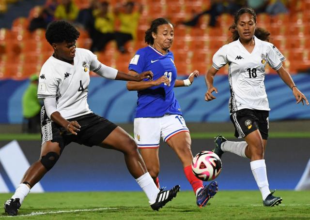 France's forward Airine Fontaine (C), Fiji's defender Seruwaia Laulaba (L) and midfielder Katarina Nailele fight for the ball during the 2024 FIFA U-20 Women's World Cup match between Fiji and France at the Atanasio Girardot stadium in Medellin, Colombia, on September 6, 2024. (Photo by JAIME SALDARRIAGA / AFP)