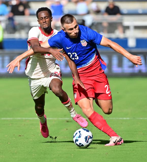 Canada's midfielder Ali Ahmed (L) and United States' defender Kristoffer Lund fight for the ball in the second half of an international friendly football match between USA and Canada at Children's Mercy Park in Kansas City, Kansas, on September 7, 2024. (Photo by Tim Vizer / AFP)