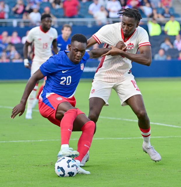 United States' forward Folarin Balogun (L) and Canada's defender Moise Bombito fight for the ball in the second half of an international friendly football match between USA and Canada at Children's Mercy Park in Kansas City, Kansas, on September 7, 2024. (Photo by Tim Vizer / AFP)