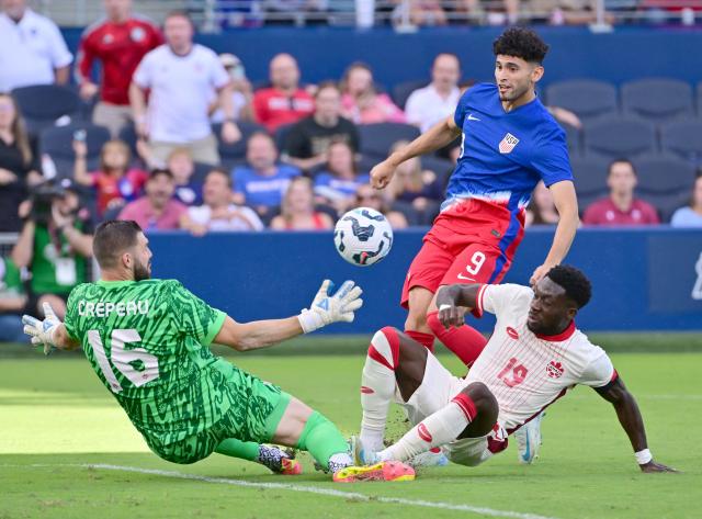 Canada's goalkeeper Maxime Crepeau (L) drops to block a shot by United States' forward Ricardo Pepi (C) with help from Canada's defender Alphonso Davies (R) in the second half of an international friendly football match between USA and Canada at Children's Mercy Park in Kansas City, Kansas, on September 7, 2024. (Photo by Tim Vizer / AFP)