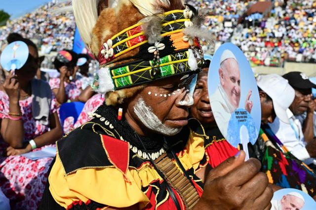 Faithful hold up fans with the portrait of Pope Francis as he leads holy mass at Sir John Guise Stadium in Port Moresby, Papua New Guinea, on September 8, 2024. Pope Francis is leading holy mass at the Sir Guise Stadium during his four day visit to Papua New Guinea from September 6-9. (Photo by Tiziana FABI / AFP)