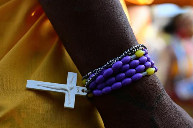 A person wears a rosary on their wrist as Pope Francis leads holy mass at Sir John Guise Stadium in Port Moresby, Papua New Guinea, on September 8, 2024. Pope Francis is leading holy mass at the Sir Guise Stadium during his four day visit to Papua New Guinea from September 6-9. (Photo by Tiziana FABI / AFP)