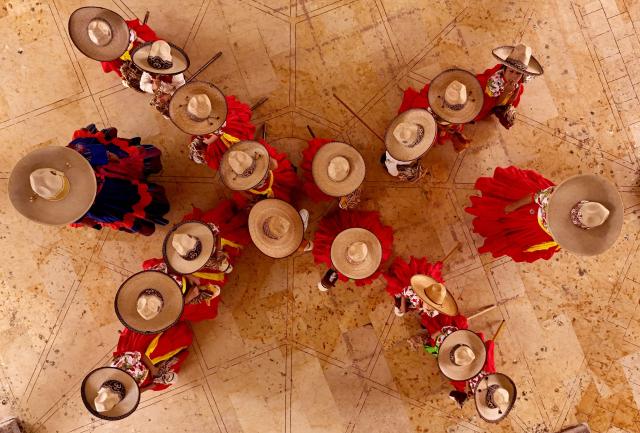 Aerial view of a students attending a class at the “Caballito de Palo” Charreria Sports Academy in Ameca, Jalisco state, Mexico, September 7, 2024. Charreria Sports Academy "Caballito de Palo" offers classes for girls aged 3-8 using a wooden hobby horse, promoting Mexican traditions during September Mexico's Independence celebrations. The traditional charreria is a sport arising from equestrian activities and livestock traditions and has been a part of Mexican culture since colonial times. It was declared the Intangible Cultural Heritage of Humanity by UNESCO in 2016. (Photo by ULISES RUIZ / AFP)