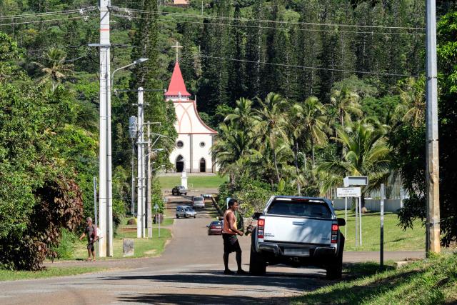 (FILES) This photograph shows the Church of Our Lady of the Assumption in Vao, on the Iles Des Pins or Isle of Pines, on the southern archipelago of the French Pacific territory of New Caledonia on May 17, 2021. Since mid-July, five Catholic buildings have been targeted by arson attacks in New Caledonia. The perpetrators of most of these acts remain unidentified, but these exactions raise questions in an archipelago where the weight of religion remains important. (Photo by Theo Rouby / AFP)