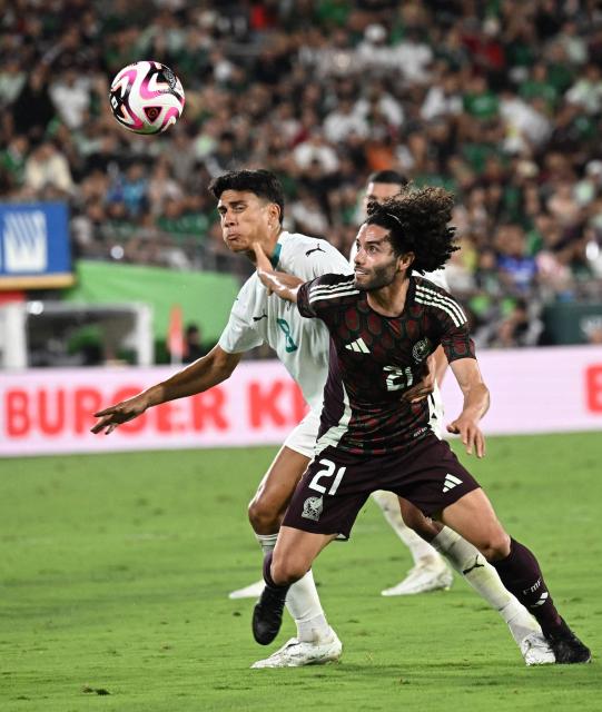 Mexico's #21 Cesar Huerta and New Zealand's #08 Marco Stamenic vie for the ball during the international friendly football match between Mexico and New Zealand at the Rose Bowl Stadium in Pasadena, California, on September 7, 2024. (Photo by Frederic J. BROWN / AFP)