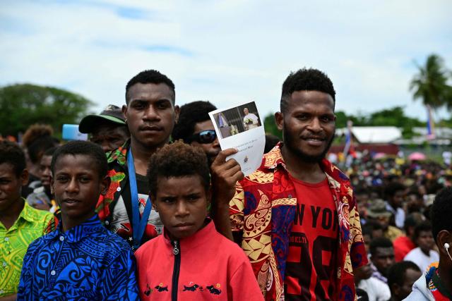 Faithful of the Diocese of Vanimo wait for the arrival of Pope Francis at the Esplanade in front of Holy Cross Cathedral in Vanimo, Papua New Guinea on September 8, 2024. (Photo by Tiziana FABI / AFP)