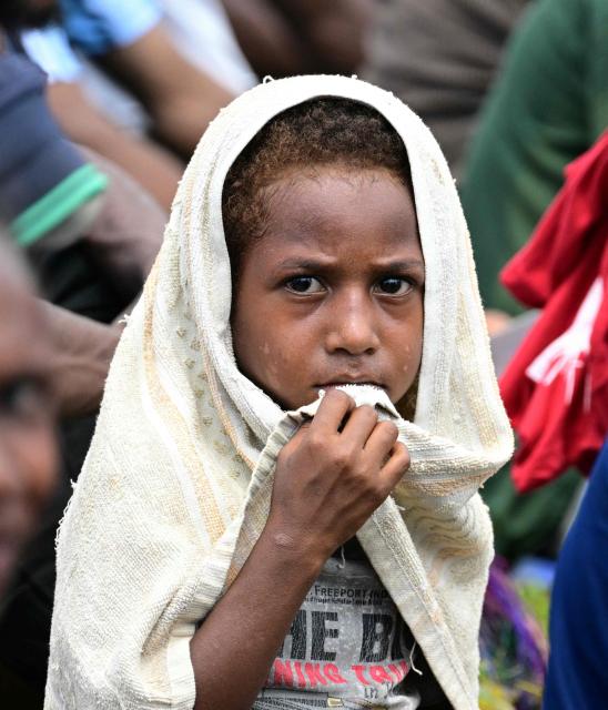 A child of the Diocese of Vanimo waits for the arrival of Pope Francis at the Esplanade in front of Holy Cross Cathedral in Vanimo, Papua New Guinea on September 8, 2024. (Photo by Tiziana FABI / AFP)