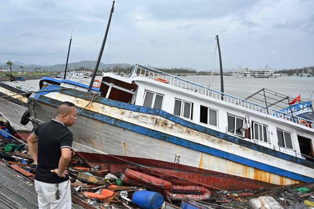 A man checks boats damaged after Super Typhoon Yagi hit Ha Long bay, in Quang Ninh province, on September 8, 2024. Super Typhoon Yagi uproots thousands of trees, sweeps ships and boats out to sea and rips roofs off houses in northern Vietnam, after leaving a trail of destruction in southern China and the Philippines. (Photo by Nhac NGUYEN / AFP)