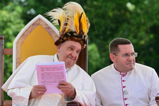 Pope Francis (L) takes part in a meeting with Catholic faithful of the diocese of Vanimo in front of Holy Cross Cathedral in Vanimo, Papua New Guinea, on September 8, 2024. (Photo by Tiziana FABI / AFP)