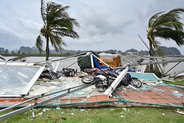 This picture shows swept motorbikes with the debris of destroyed waiting lounges on the shore after Super Typhoon Yagi hit Ha Long bay, in Quang Ninh province, on September 8, 2024. Super Typhoon Yagi uproots thousands of trees, sweeps ships and boats out to sea and rips roofs off houses in northern Vietnam, after leaving a trail of destruction in southern China and the Philippines. (Photo by Nhac NGUYEN / AFP)