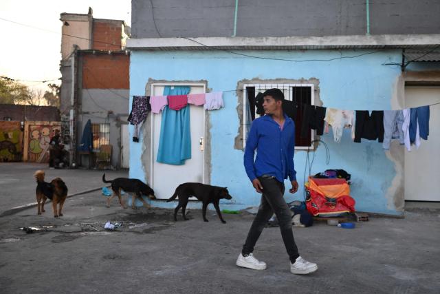 A man walks on a street in La Boca neighborhood in Buenos Aires on September 20, 2024. (Photo by LUIS ROBAYO / AFP)