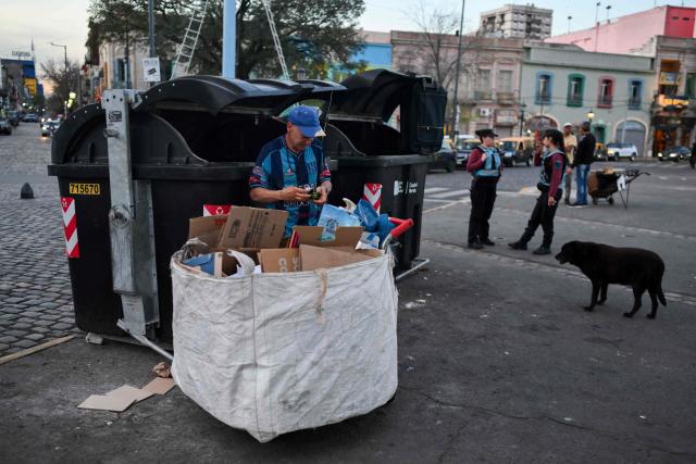 A man collects recyclable items at La Boca neighborhood in Buenos Aires on September 20, 2024. (Photo by LUIS ROBAYO / AFP)