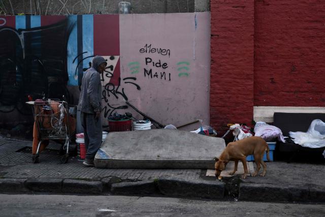 A homeless man stands on a street in Buenos Aires on September 20, 2024. (Photo by LUIS ROBAYO / AFP)