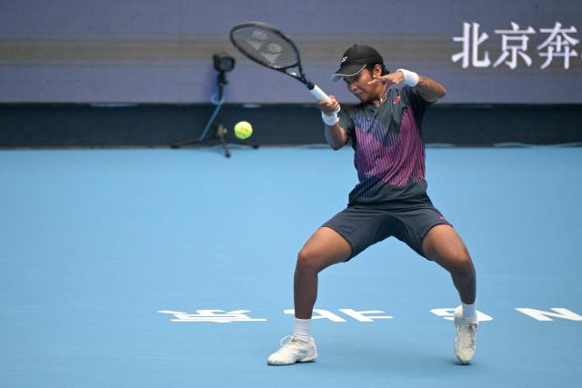 Thailand’s Mananchaya Sawangkaew hits a return to Belarus' Aryna Sabalenka during their women's singles match at the China Open tennis tournament in Beijing on September 28, 2024. (Photo by Jade Gao / AFP)