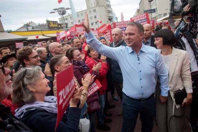 Leader of left-wing Social Democratic Party (SPOe) and top candidate Andreas Babler and wife Karin Blum (R) greet supporters during an election campaign rally in Vienna, Austria on September 28, 2024, on the eve of Austria's general election. Legislative elections will be held on September 29, 2024 to elect the 28th National Council (Nationalrat), the lower house of Austria's bicameral parliament. (Photo by Alex HALADA / AFP)