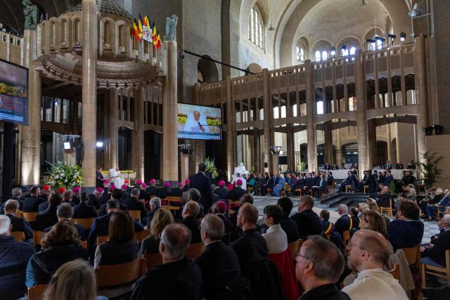 Pope Francis is seen on a screen as he meets with bishops, priests, deacons, consecrated persons, seminarians and pastoral workers at The Koekelberg Basilica of the Sacred Heart in Brussels on September 28, 2024. The pope is on a four-day apostolic journey to Luxembourg and Belgium. (Photo by NICOLAS MAETERLINCK / various sources / AFP)