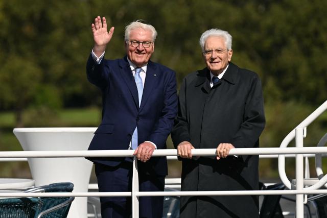 Italian President Sergio Mattarella (R) and German President Frank-Walter Steinmeier wave from a boat during a tour along the Rhine river to Cologne, in Bonn, western Germany, September 28, 2024, during the Italien president's state visit to Germany. (Photo by INA FASSBENDER / AFP)