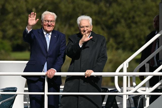 Italian President Sergio Mattarella (R) and German President Frank-Walter Steinmeier wave from a boat during a tour along the Rhine river to Cologne, in Bonn, western Germany, September 28, 2024, during the Italian president's state visit to Germany. (Photo by INA FASSBENDER / AFP)