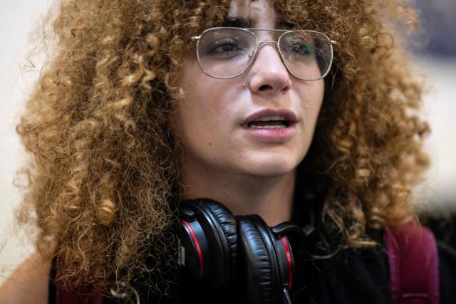 Lebanese Yara Antoun, 23 years old, repatriated citizen, speaks to the press upon her arrival in the Portuguese Air Force C130 aircraft that brought 41 repatriated citizens on the flight from Beirut to Figo Maduro airport in Lisbon on October 4, 2024. The flight brought repatriated citizens from Beirut, Lebanon, 16 of whom are Portuguese, and the other family members are of other nationalities (8 from Lebanon, 5 from Spain, 8 from São Tomé, 1 from Brazil, 1 from Angola, 1 from Russia, and 1 from France). (Photo by PATRICIA DE MELO MOREIRA / AFP)