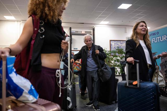 Repatriated citizens from Lebanon are pictured upon their arrival in the Portuguese Air Force C130 aircraft that brought 41 repatriated citizens on the flight from Beirut to Figo Maduro airport in Lisbon on October 4, 2024. The flight brought repatriated citizens from Beirut, Lebanon, 16 of whom are Portuguese, and the other family members are of other nationalities (8 from Lebanon, 5 from Spain, 8 from São Tomé, 1 from Brazil, 1 from Angola, 1 from Russia, and 1 from France). (Photo by PATRICIA DE MELO MOREIRA / AFP)