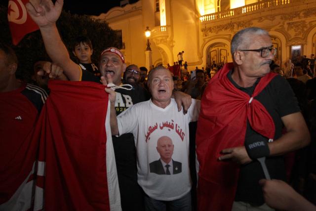 Supporters of Tunisia's President celebrate after the announcement of the first estimates in favor of the incumbent President, on the Avenue Habib Bourguiba in Tunis on October 6, 2024. Tunisians voted on October 6, 2024, in a presidential election largely expected to see incumbent Kais Saied secure another five years in office while his main critics -- including one contender -- are behind bars. (Photo by YASSINE MAHJOUB / AFP)