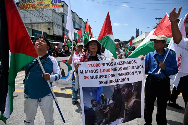 Demonstrators wave Palestinian flags as they take part in a march demanding peace in Palestinian territories and Lebanon within the framework of the first anniversary of the Israel-Hamas conflict in Guatemala City on October 6, 2024. (Photo by JOHAN ORDONEZ / AFP)