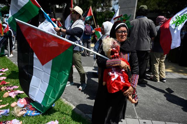 A demonstrator holds a Palestinian flag as she takes part in a march demanding peace in Palestinian territories and Lebanon within the framework of the first anniversary of the Israel-Hamas conflict in Guatemala City on October 6, 2024. (Photo by JOHAN ORDONEZ / AFP)