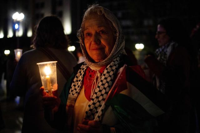 A demonstrator holds a candle during a pro-Palestinian vigil within the framework of the first anniversary of the Israel-Hamas conflict in Buenos Aires on October 6, 2024. (Photo by TOMAS CUESTA / AFP)