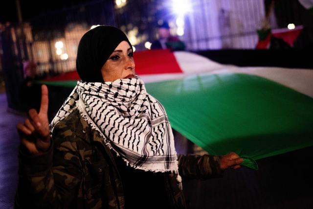 A demonstrator holds a giant Palestinian flag during a pro-Palestinian vigil within the framework of the first anniversary of the Israel-Hamas conflict in Buenos Aires on October 6, 2024. (Photo by TOMAS CUESTA / AFP)