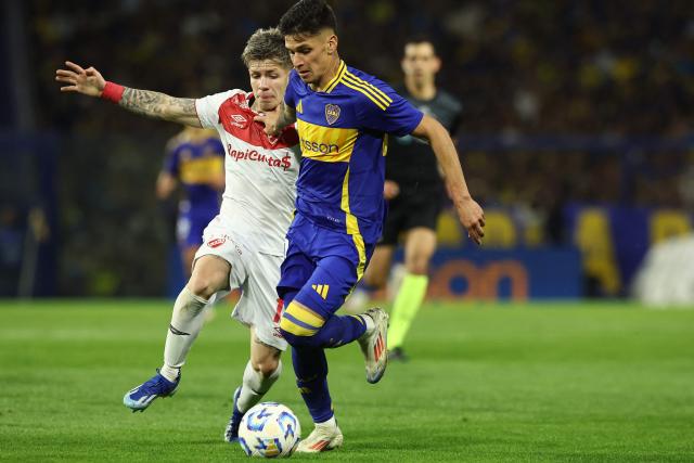 Argentinos Juniors' defender Kevin Coronel (L) and Boca Juniors' forward Brian Aguirre fight for the ball during the 2024 Argentine Professional Football League tournament match between Boca Juniors and Argentino Juniors at the Alberto Jose Armando 'La Bombonera' Stadium in Buenos Aires on October 6, 2024. (Photo by ALEJANDRO PAGNI / AFP)