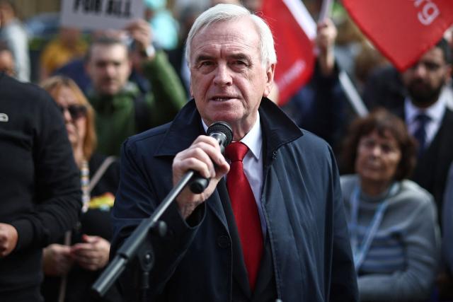 Independent MP John McDonnell speaks as people gather with placards outside parliament to protest against the cut in winter fuel allowance, in central London on October 7, 2024. (Photo by HENRY NICHOLLS / AFP)