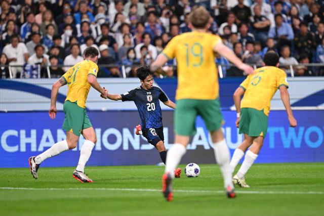 Japan's Takefusa Kubo passes the ball during the FIFA World Cup 2026 Asian zone qualifiers football between Japan and Australia at Saitama Stadium in Saitama on October 15, 2024. (Photo by Philip FONG / AFP)