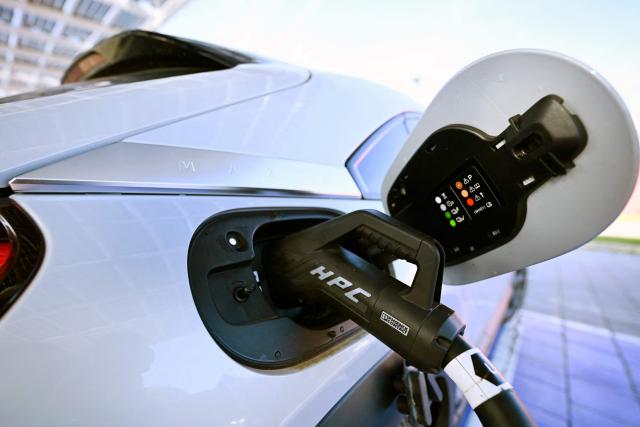 A charger socket at an electric car is pictured at a charging station in Kamen, western Germany, on October 15, 2024. (Photo by Ina FASSBENDER / AFP)