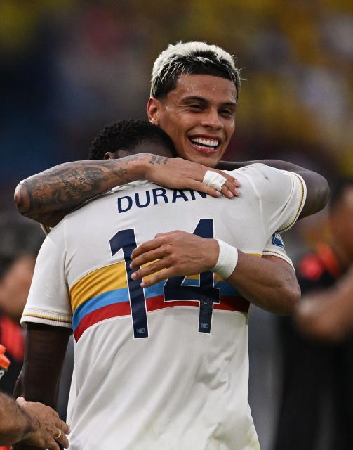 Colombia's forward #14 Jhon Durán celebrates with Colombia's midfielder #06 Richard Ríos after scoring during the 2026 FIFA World Cup South American qualifiers football match between Colombia and Chile at the Roberto Melendez Metropolitan stadium in Barranquilla, Colombia, on October 15, 2024. (Photo by Raul ARBOLEDA / AFP)