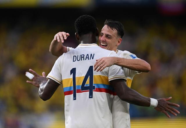 Colombia's forward #14 Jhon Durán celebrates with Colombia's defender #04 Santiago Arias after scoring during the 2026 FIFA World Cup South American qualifiers football match between Colombia and Chile at the Roberto Melendez Metropolitan stadium in Barranquilla, Colombia, on October 15, 2024. (Photo by Raul ARBOLEDA / AFP)