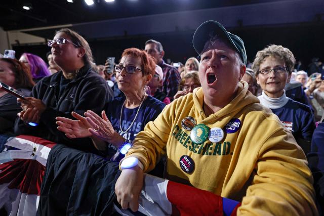 Supporters of US Vice President and Democratic presidential candidate Kamala Harris cheer as she speaks during a campaign event at the Resch Expo Center in Green Bay, Wisconsin, October 17, 2024. (Photo by KAMIL KRZACZYNSKI / AFP)