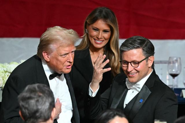 Former US President and Republican presidential candidate Donald Trump (L) chats wih US Speaker of the House Mike Johnson (R) alongside former US First Lady Melania Trump during the 79th Annual Alfred E. Smith Memorial Foundation Dinner at the Hilton Midtown in New York, October 17, 2024. (Photo by TIMOTHY A. CLARY / AFP)