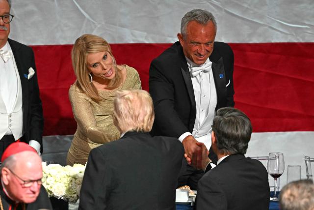 Former US President and Republican presidential candidate Donald Trump (L) and US Speaker of the House Mike Johnson (R) greet US politician Robert F. Kennedy Jr. (C) and his wife actress Cheryl Hines during the 79th Annual Alfred E. Smith Memorial Foundation Dinner at the Hilton Midtown in New York, October 17, 2024. (Photo by TIMOTHY A. CLARY / AFP)