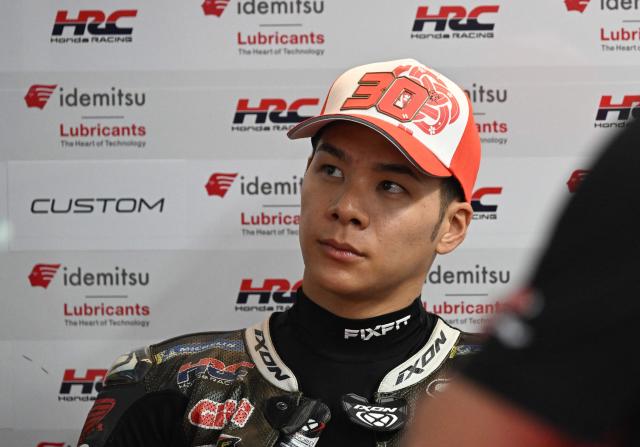 Idemitsu Honda LCR's Japanese rider Takaaki Nakagami relaxes in the garage as rain cancels the first practice session of the Australian MotoGP Grand Prix on Philip Island on October 18, 2024. (Photo by Paul CROCK / AFP)