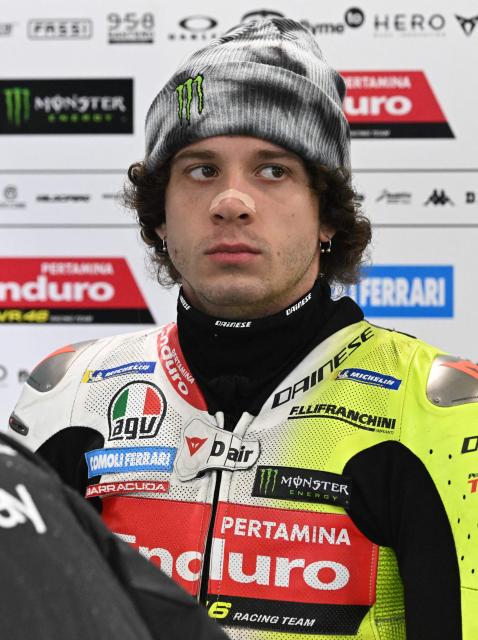 Pertamina Enduro VR46 Racing Team's Italian rider Marco Bezzecchi relaxes in the garage as rain cancels the first practice session of the Australian MotoGP Grand Prix on Philip Island on October 18, 2024. (Photo by Paul CROCK / AFP)