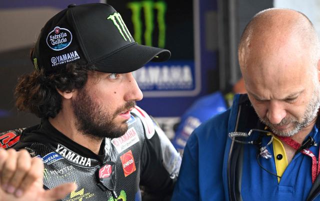 Monster Energy Yamaha MotoGP Team's Spanish rider Alex Rins relaxes in the garage as rain cancels the first practice session of the Australian MotoGP Grand Prix on Philip Island on October 18, 2024. (Photo by Paul CROCK / AFP)