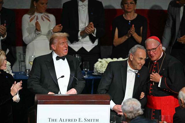 Former US President and Republican presidential candidate Donald Trump (L) speaks alongside US Senate Majority Leader Chuck Schumer (C) and Archbishop of New York Timothy M. Dolan (R) during the 79th Annual Alfred E. Smith Memorial Foundation Dinner at the Hilton Midtown in New York, October 17, 2024. (Photo by Timothy A. CLARY / AFP)