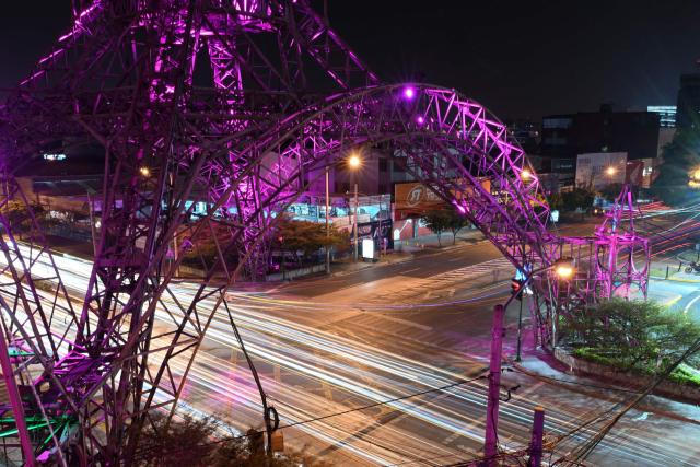 The Tower of the Reformer illuminated by pink lights as part of a worldwide campaign to mark "The World Day against Breast Cancer" is pictured in Guatenmala City on October 17, 2024.  (Photo by JOHAN ORDONEZ / AFP)