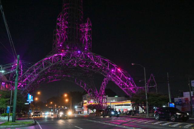 The Tower of the Reformer illuminated by pink lights as part of a worldwide campaign to mark "The World Day against Breast Cancer" is pictured in Guatenmala City on October 17, 2024.  (Photo by JOHAN ORDONEZ / AFP)