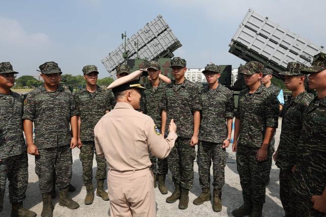 Soldiers stands in front of an anti-ship missile group named “Hai Feng” at a naval base in Taoyuan on October 18, 2024. (Photo by I-Hwa CHENG / AFP)