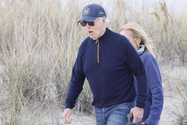 US President Joe Biden and First Lady Jill Biden walk on the beach at Gordons Pond in Rehoboth Beach, Delaware, on November 10, 2024. (Photo by Ting Shen / AFP)