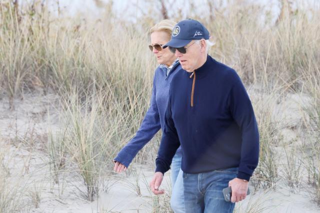 US President Joe Biden and First Lady Jill Biden walk on the beach at Gordons Pond in Rehoboth Beach, Delaware, on November 10, 2024. (Photo by Ting Shen / AFP)