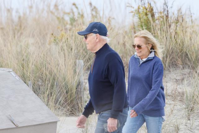 US President Joe Biden and First Lady Jill Biden walk on the beach at Gordons Pond in Rehoboth Beach, Delaware, on November 10, 2024. (Photo by Ting Shen / AFP)