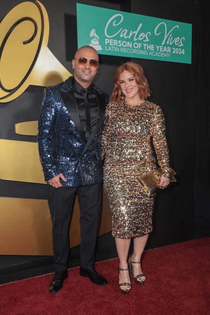 Puerto Rican rapper Wisin (L) and wife Yomaira Ortiz Feliciano attend the Latin Recording Academy's Person Of The Year gala at the Miami Beach Convention Center in Miami Beach on November 13, 2024. (Photo by Giorgio Viera / AFP)