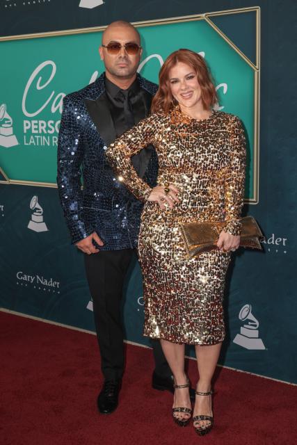 Puerto Rican rapper Wisin (L) and wife Yomaira Ortiz Feliciano attend the Latin Recording Academy's Person Of The Year gala at the Miami Beach Convention Center in Miami Beach on November 13, 2024. (Photo by Giorgio Viera / AFP)